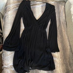 Black knit long sleeve mini dress with open back. Size medium. Good condition.